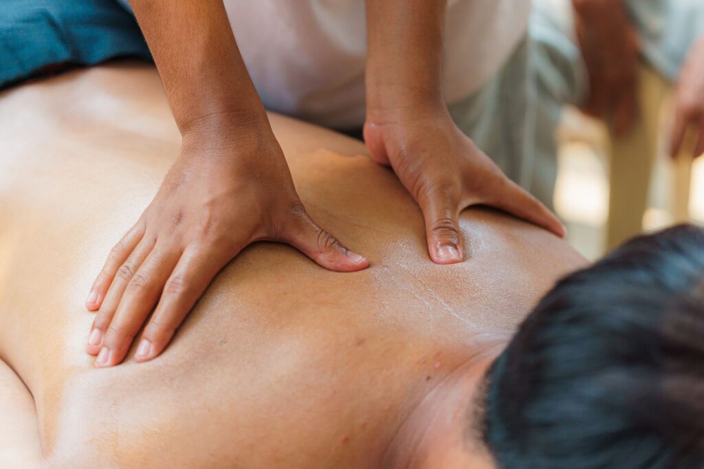 Close-up of a relaxing massage therapy session, focusing on hand technique and skin care.