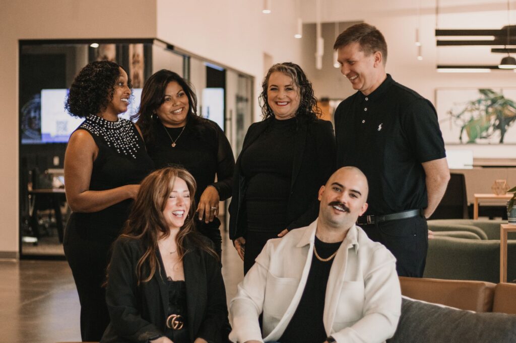 A group of professionals sharing a moment in a modern office setting.
